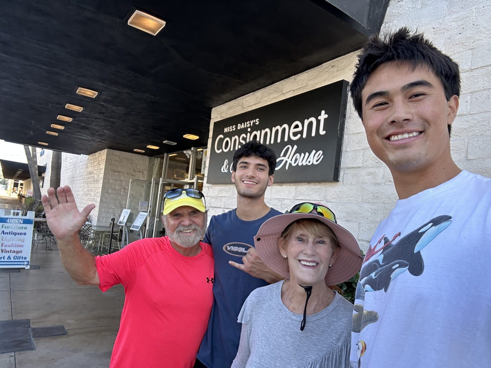 Two Student Bees smiling with clients outside a local consignment shop