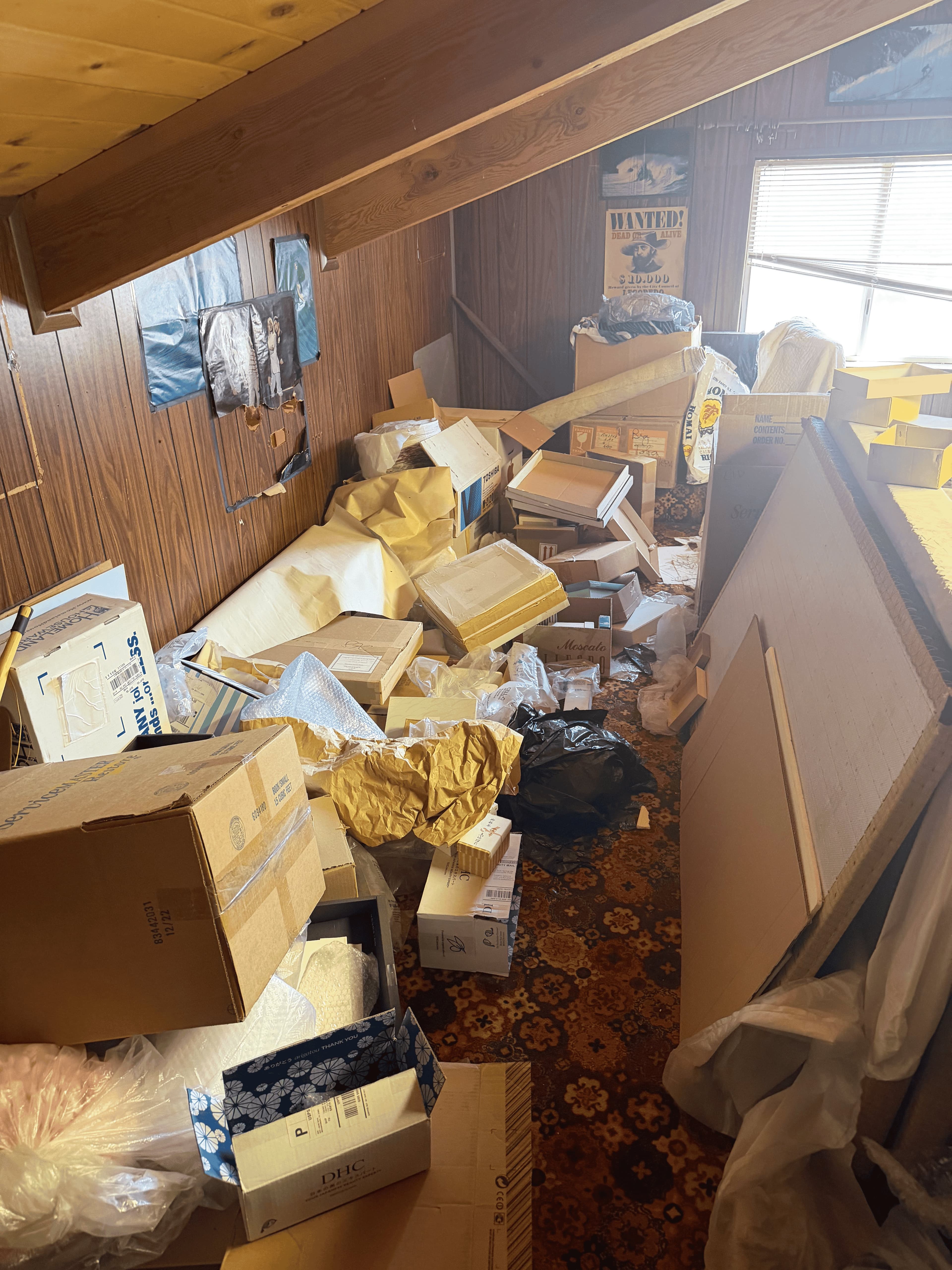 Cluttered attic storage room before cleanout