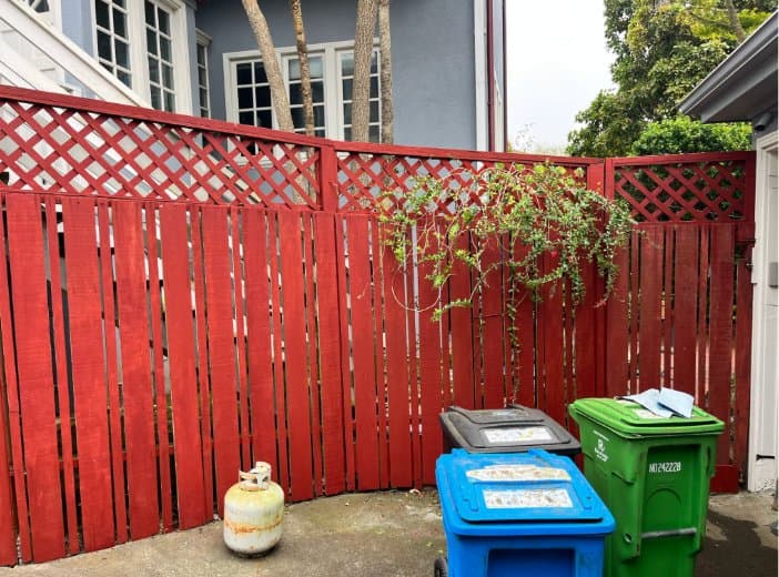 Fence painted red after restoration
