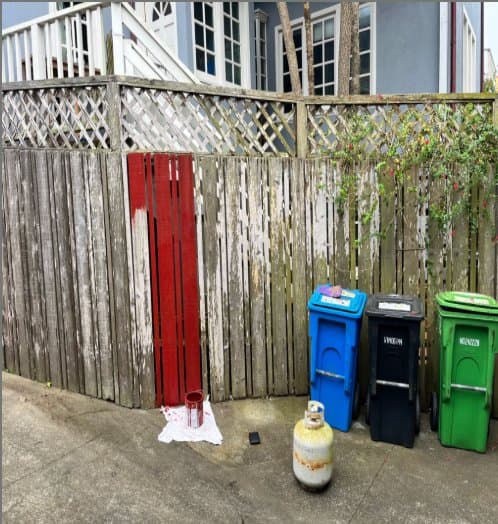 Weathered grey wooden fence before painting