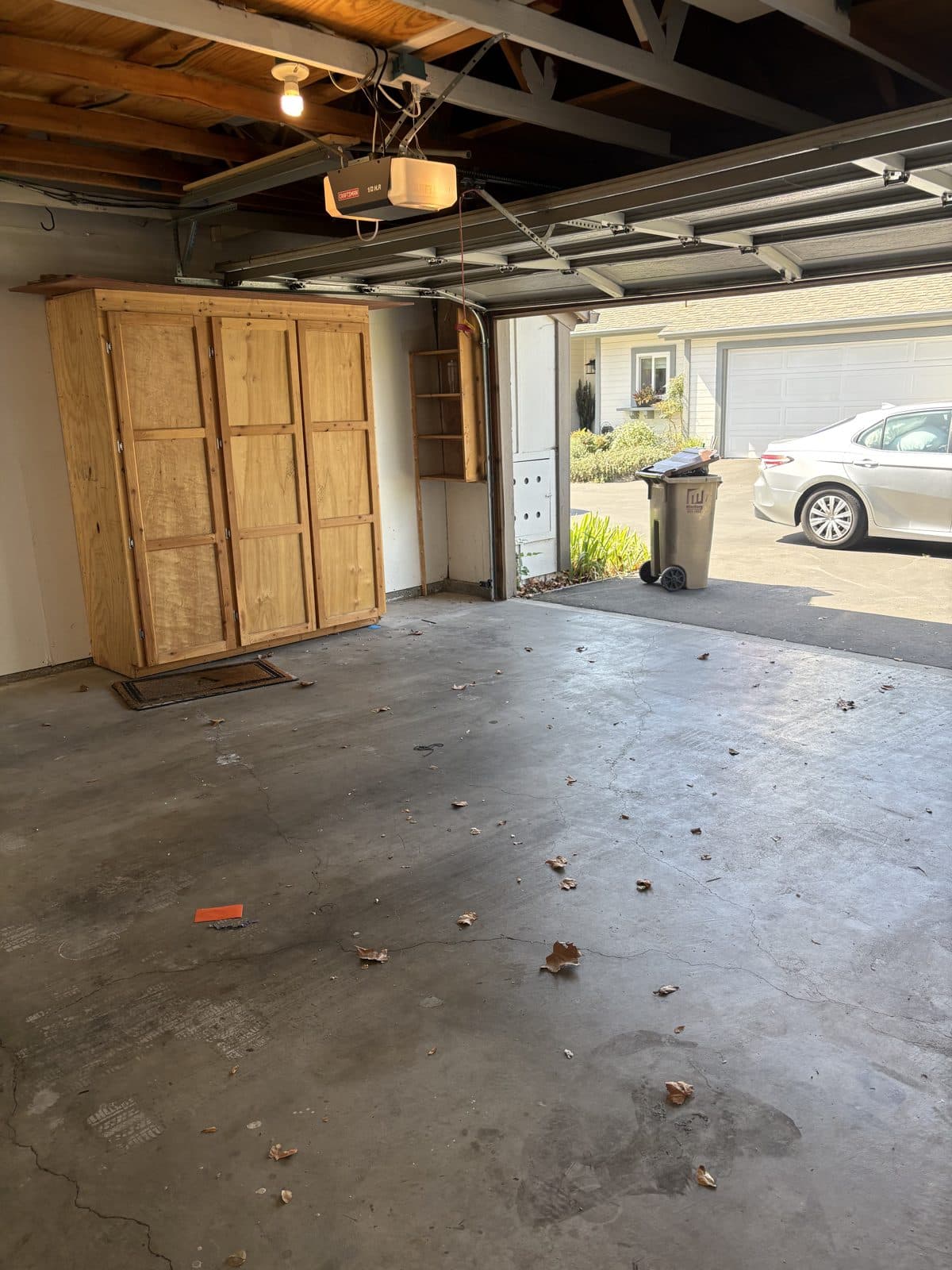 The same garage swept clean and empty after cleanout
